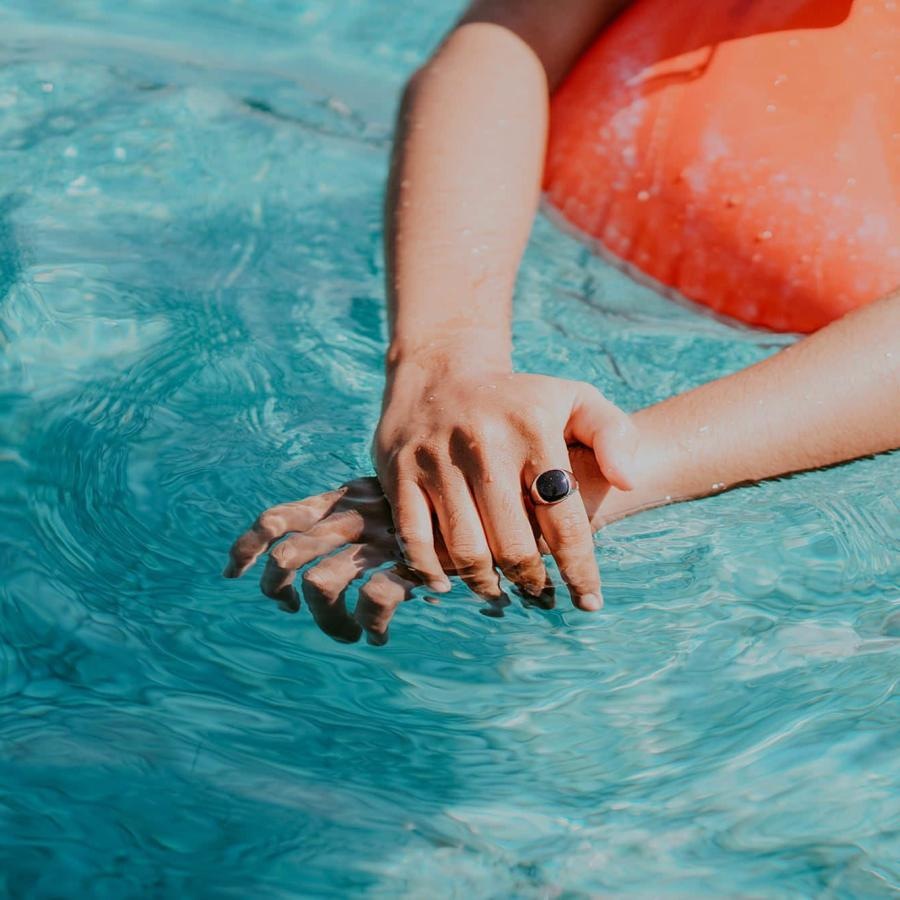 woman relaxes on a floatie in swimming pool
